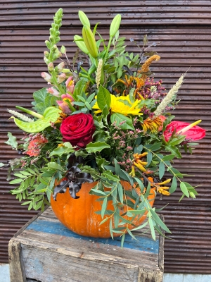 Pumpkin filled with blooms and fruits